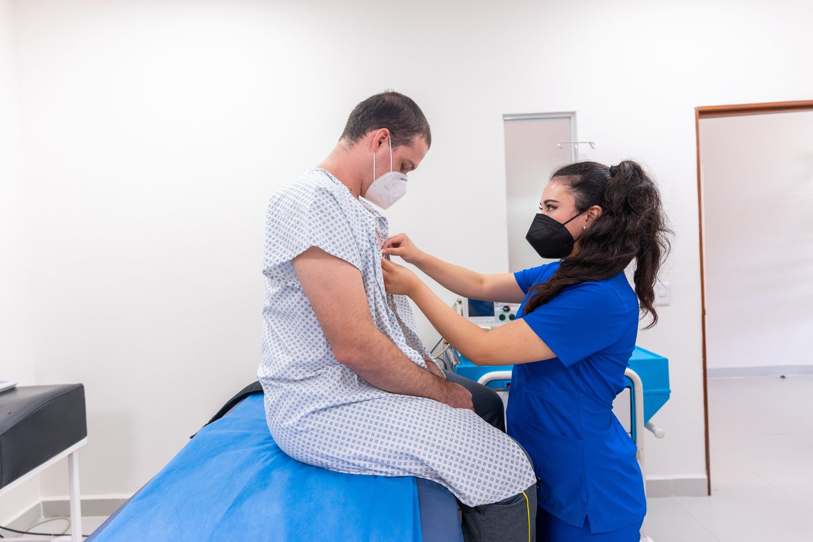 A nurse consulting with a colleague in a hospital hallway